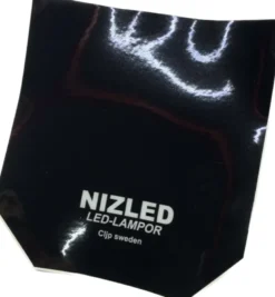 Nizled dekal till lamp-skyddslock Husqvarna -23 svart